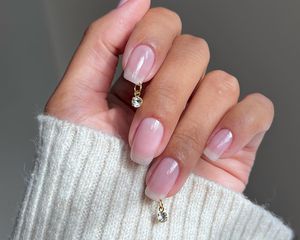 a glossy manicure with a diamond piercing