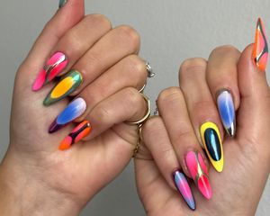 A mismatched manicure with chrome, airbrush, and ombre details