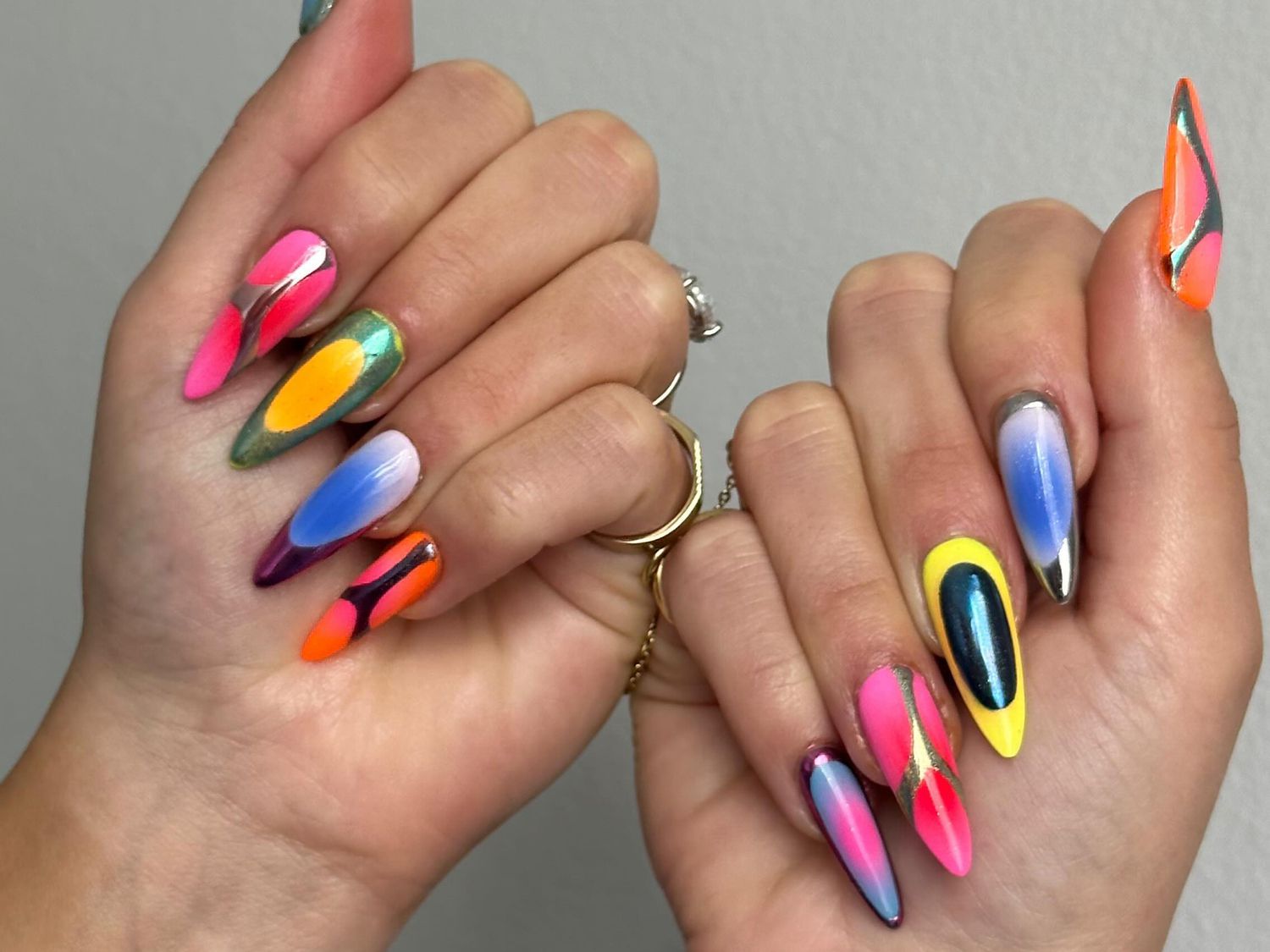 A mismatched manicure with chrome, airbrush, and ombre details