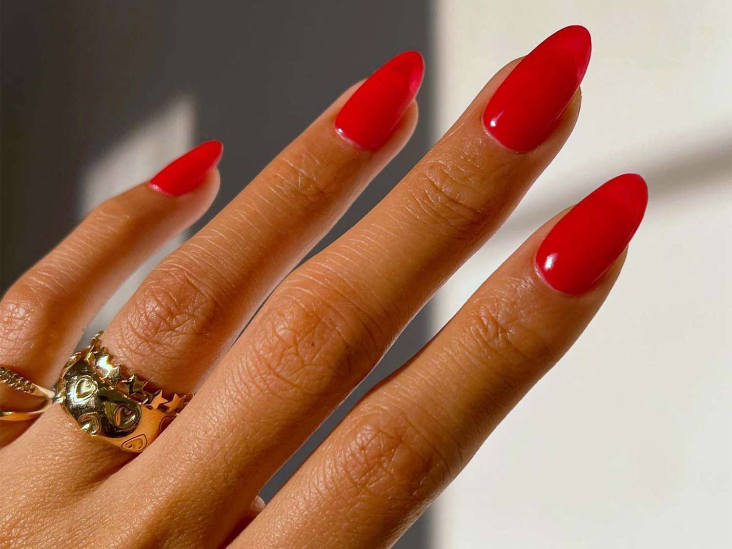 Red nail gel extension manicure.