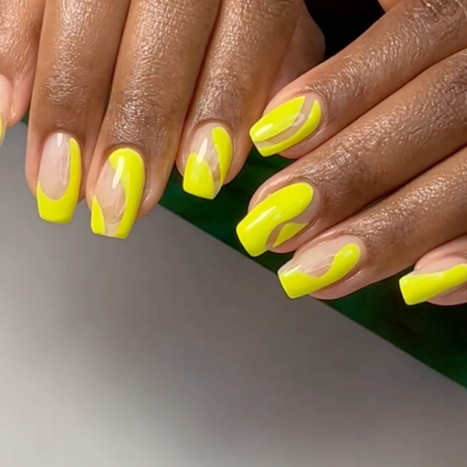 Neon yellow negative space swirl nails