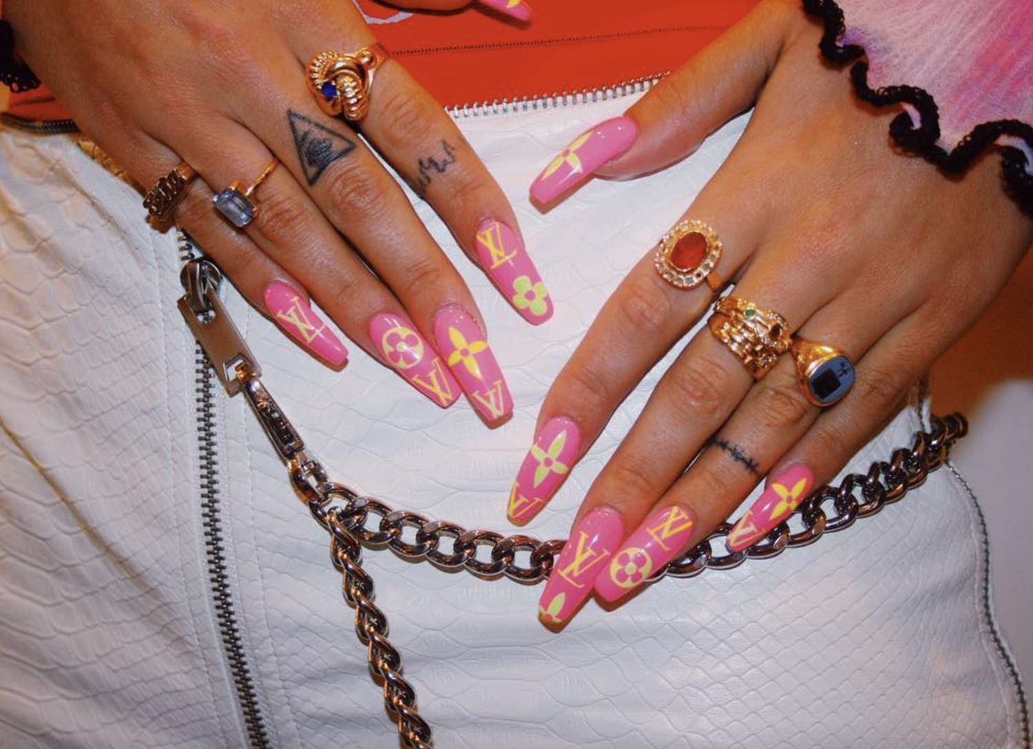 Neon pink coffin nails with bright yellow LV monogram logo