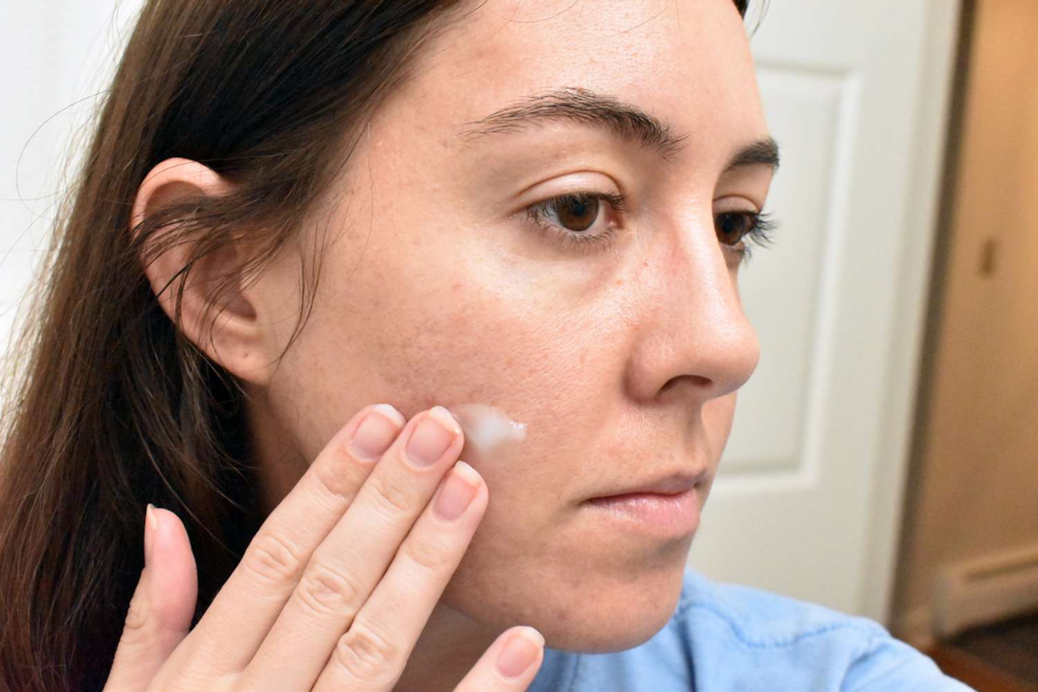 Person applying the Lightweight Neutrogena Hydro Boost Water Gel on their cheek