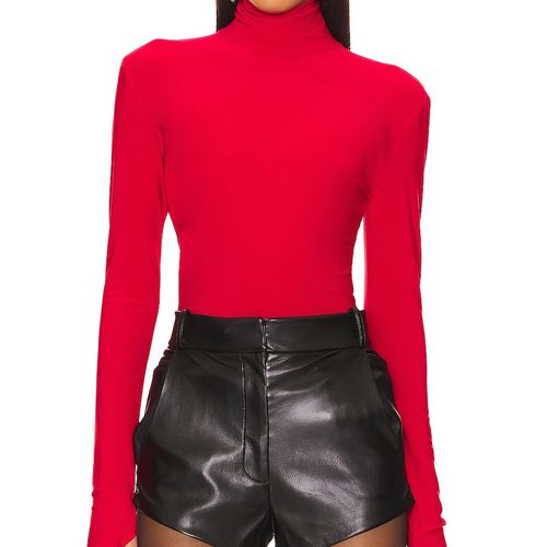 Norma Kamali x Revolve Turtle Top in tiger red on model styled with leather shorts