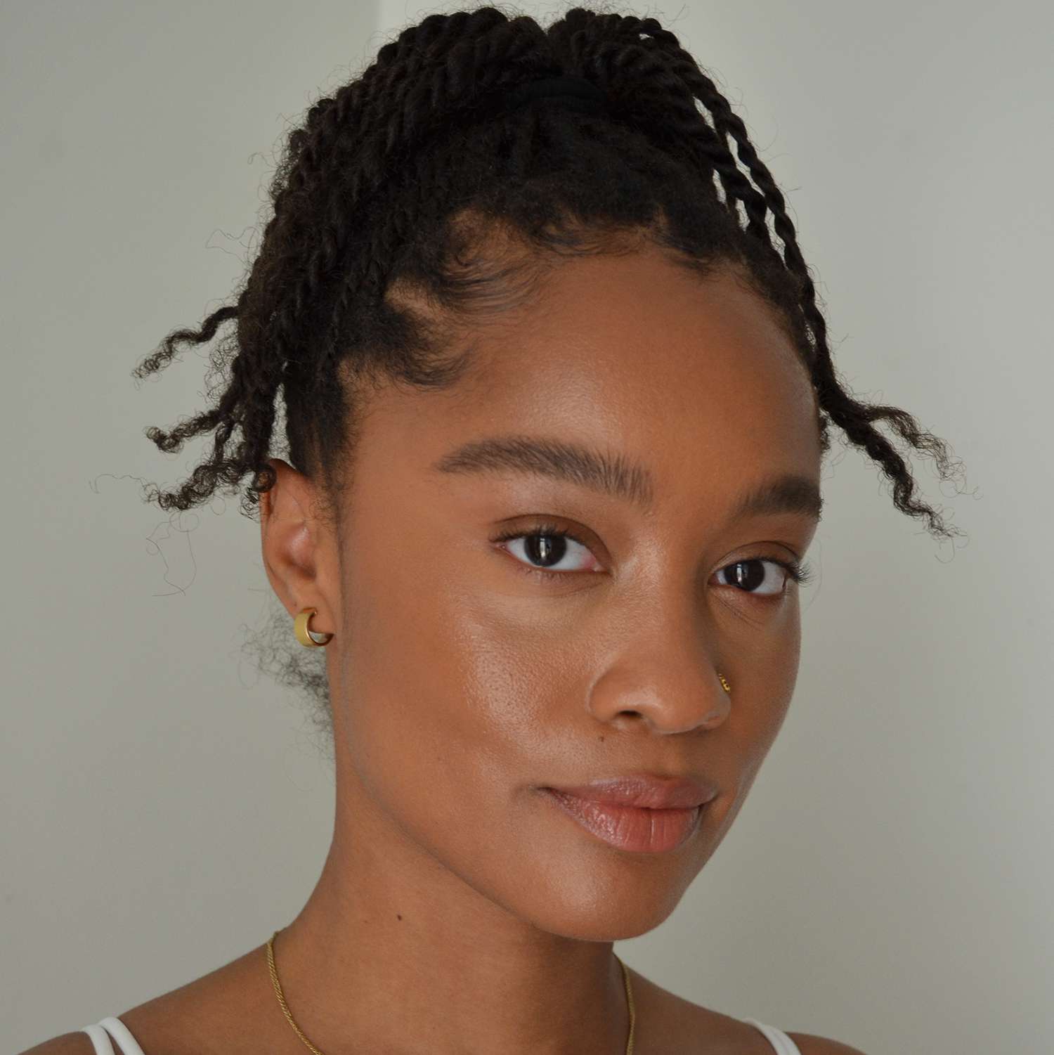 Byrdie writer Khera Alexander wearing the Kosas Wet Stick lipstick in Papaya Treat