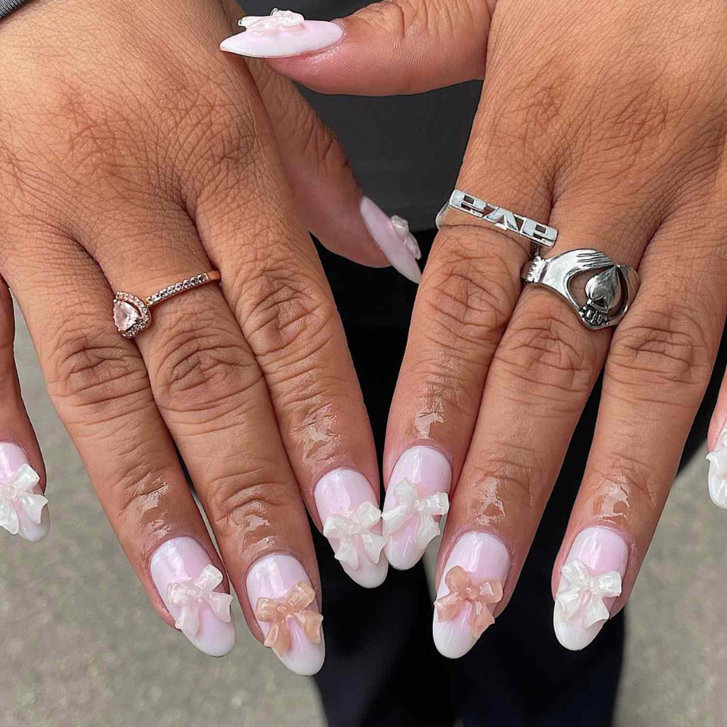 Pastel pink nails with pink and white 3D bow details