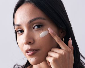 Latina Woman with Creamy Moisturizer Swatch on her Cheekbone