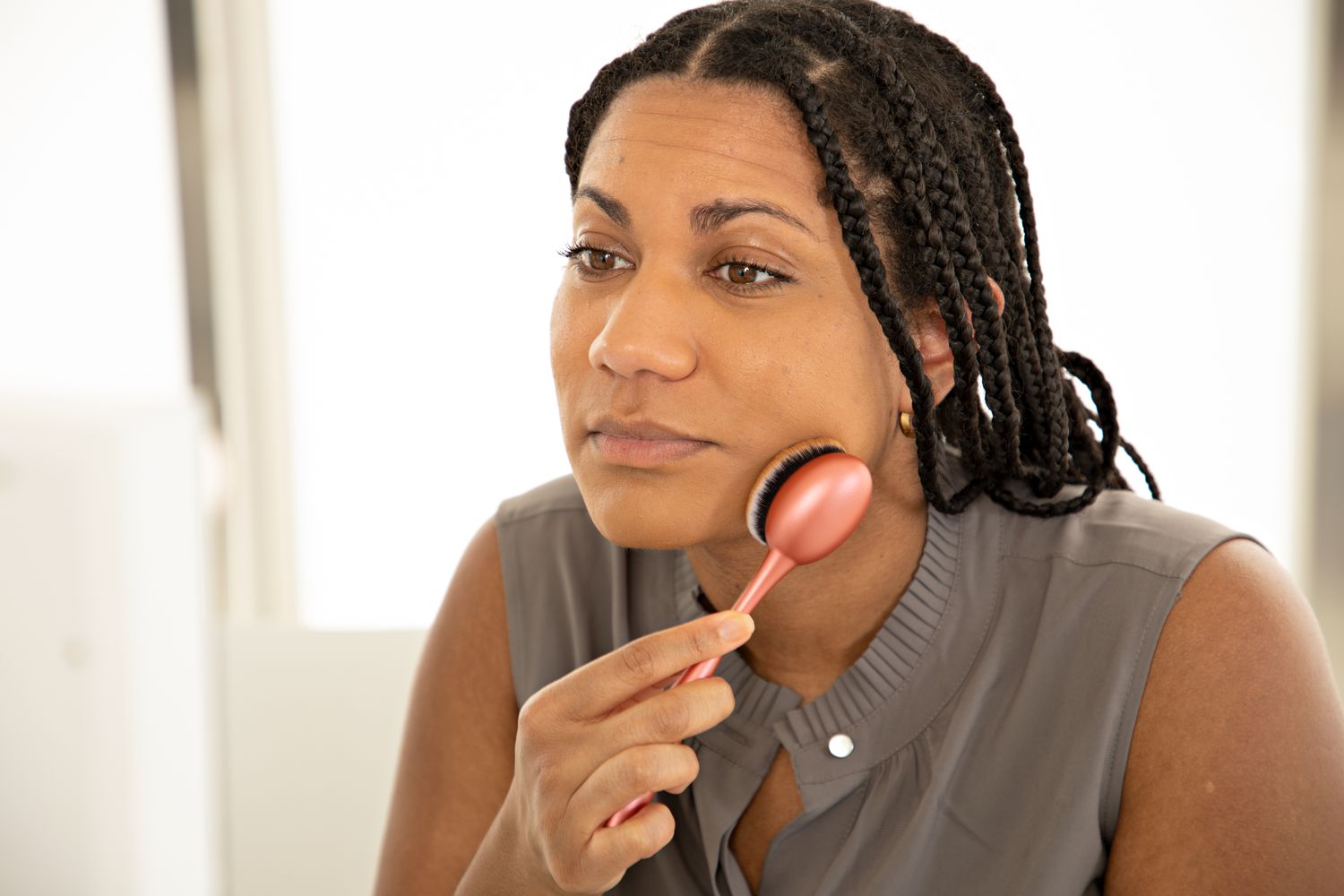 Woman using Real Techniques Blend + Blur Foundation Brush on face