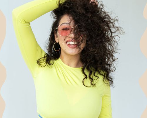 woman with curly hair smiling