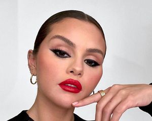 Selena Gomez selfie with red lipstick and thick black eyeliner