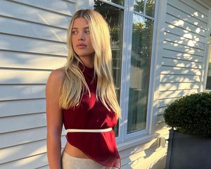 Sofia Richie Grainge with a red blouse and her blond hair in a center part