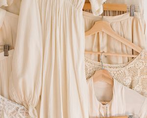 Cream-colored clothing items on neutral hangars