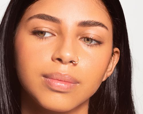 woman with nose hoop ring looking to the side