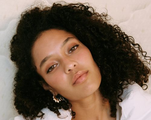 woman with curly hair on white background