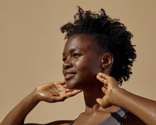 woman with acne standing in sunlight