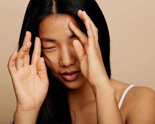 person moving hair out of face candid