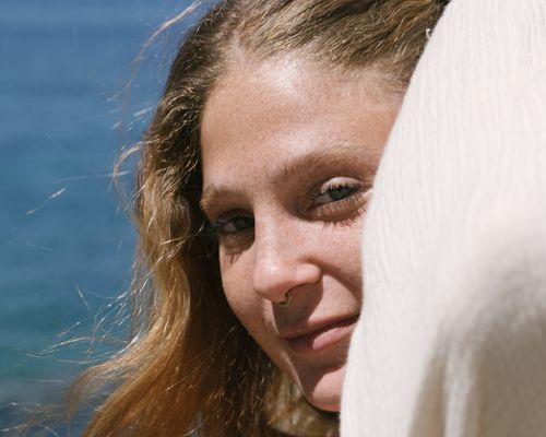 woman with septum piercing staring into sun