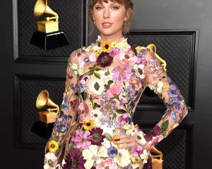 Taylor Swift wearing a floral mini dress at the 2021 Grammy Awards