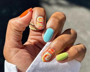 A manicure with three solid fingers and two tie-dye accent nails