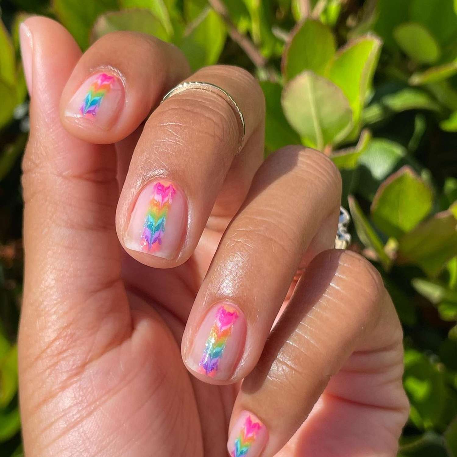 Nude nails with rainbow watercolor stripes