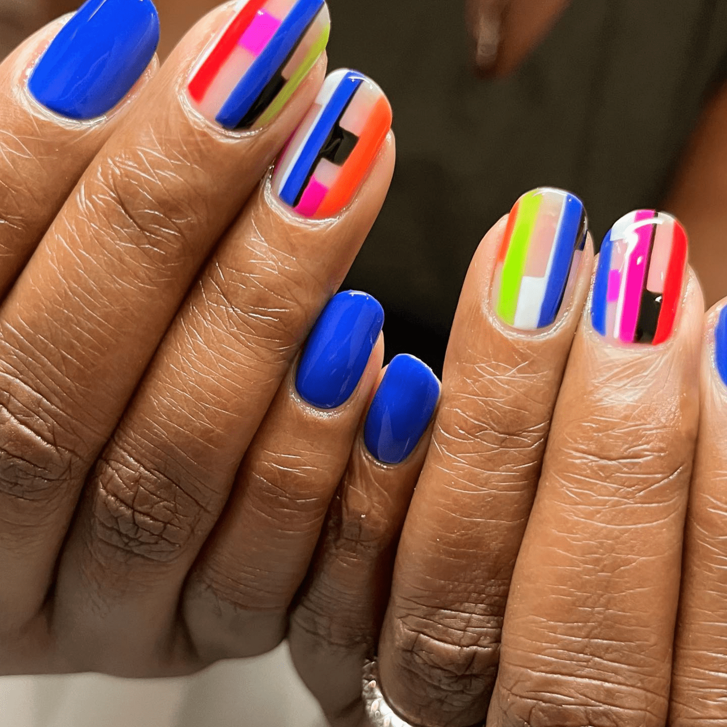 electric blue nails and multi colored negative space nails