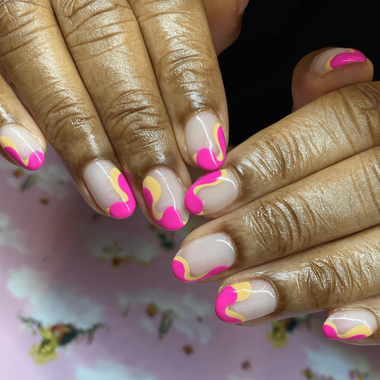 pink and yellow swirl negative space nails