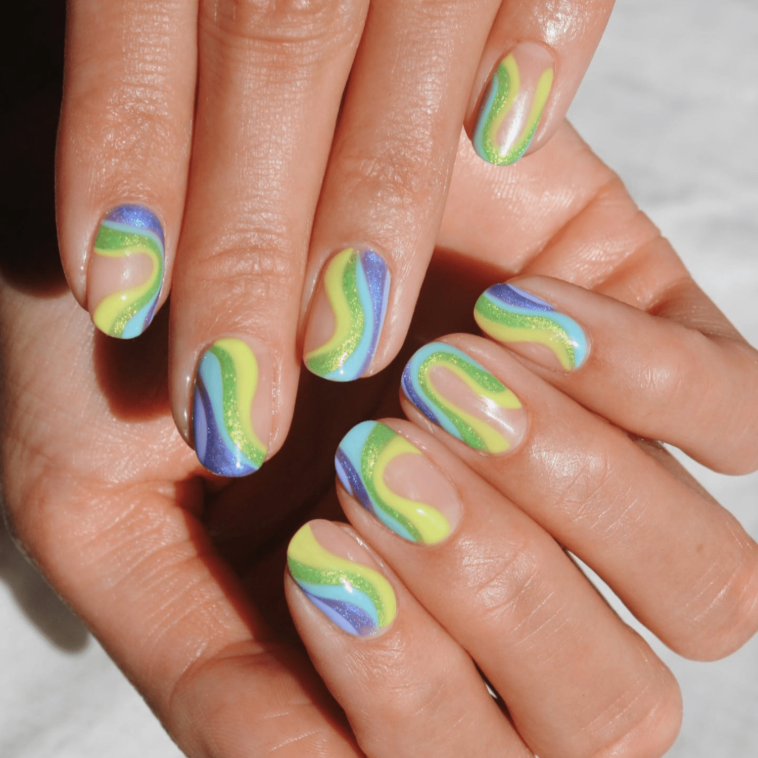 yellow, green glitter, sky blue, purple glitter swirls with negative space design