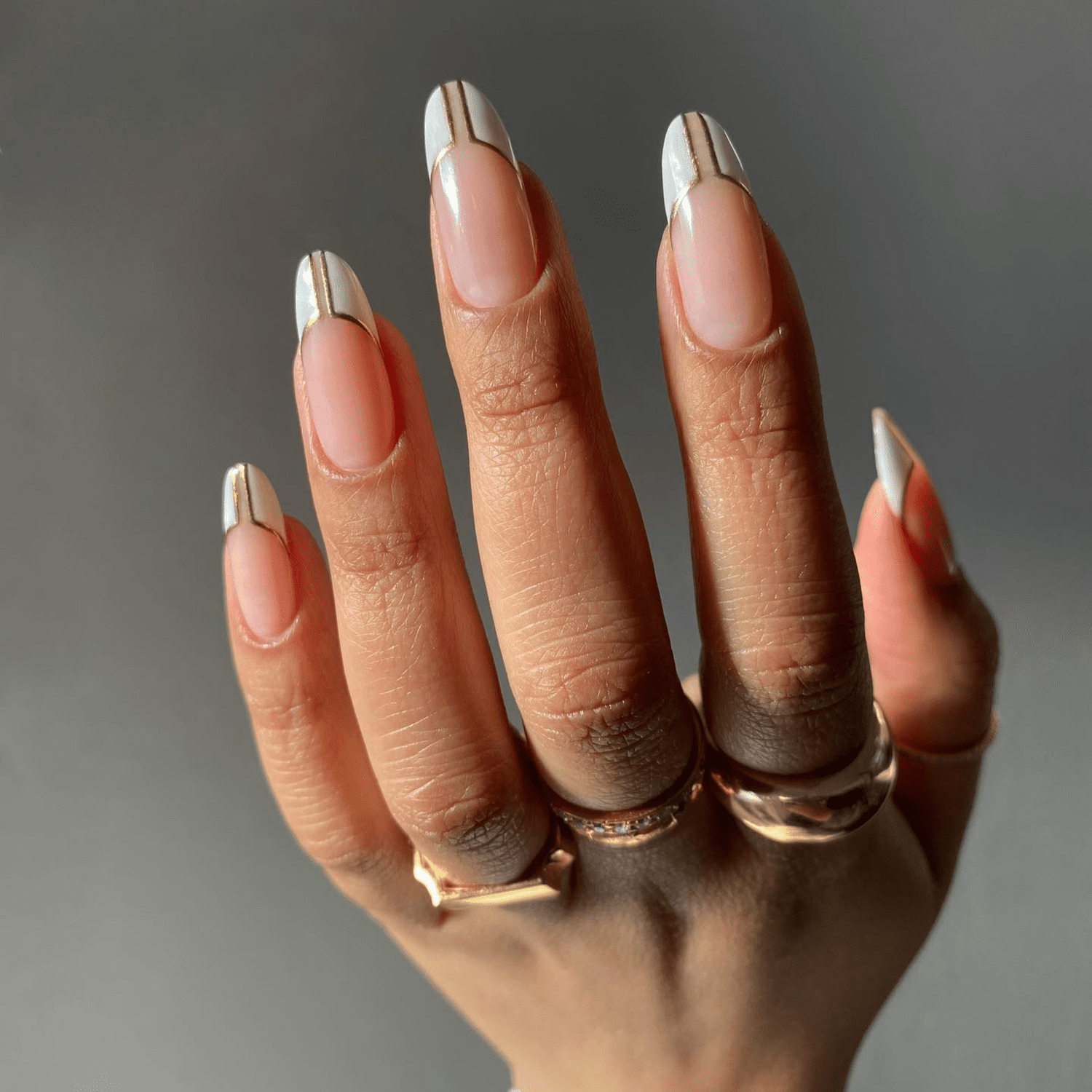 white art deco french tips and gold trim with middle negative space design