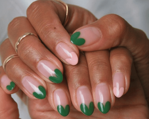 Hands with neutral nails and pink and green heart tips