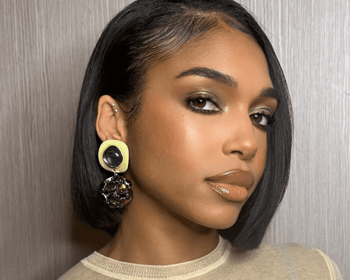 Lori Harvey in full glam with gold statement earrings and a bob