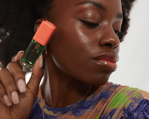 Model holding Youthforia BYO Blush Oil