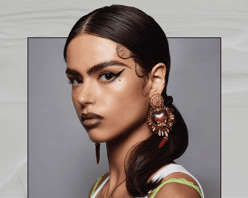 Latina Woman Wearing Heavily Winged Liner and Lined Lips 