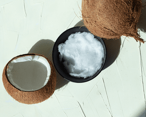 bowl of coconut oil on green background