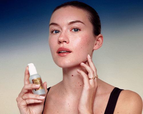 A model holding Farmacy's Honey Glow 17% Resurfacing Acid Serum