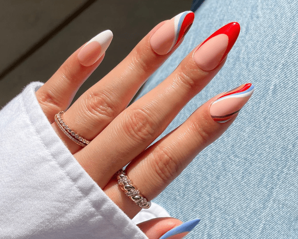 Close up of red, white, blue, orange, and purple swirl nails with accent French tips.