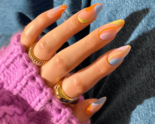 A close up of pastel swirled long nails.