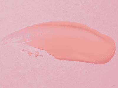 swatch of hair wax on pink background