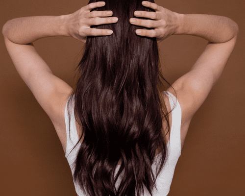 Back of woman's head, touching her hair