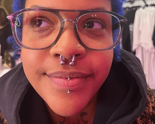 Close up of someone with multiple nose piercings and a labret piercing