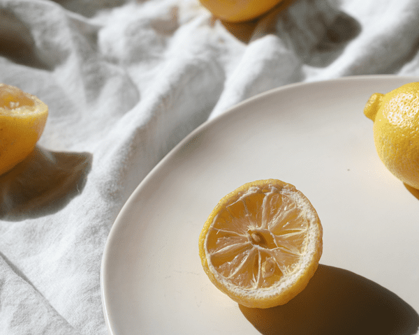 A composed tablescape with full lemons and half lemons