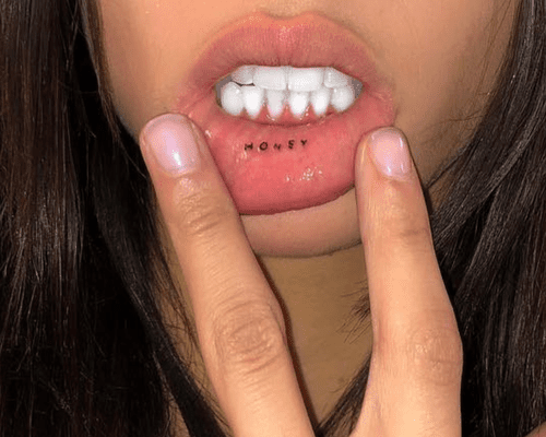 Model Yasmin Wijnaldum showing her "Honey" lip tattoo.