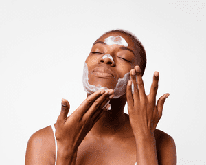 close up of woman washing face against white background