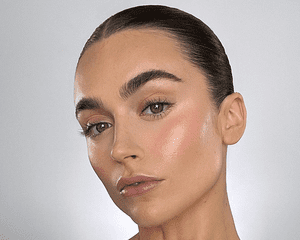 close up of woman wearing makeup with bold brows and lashes