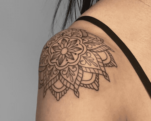 close up of mandala tattoo on woman's shoulder