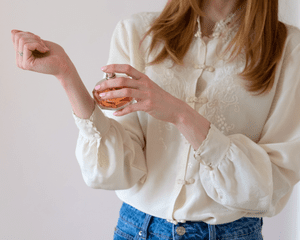 A woman spraying perfume on her wrist