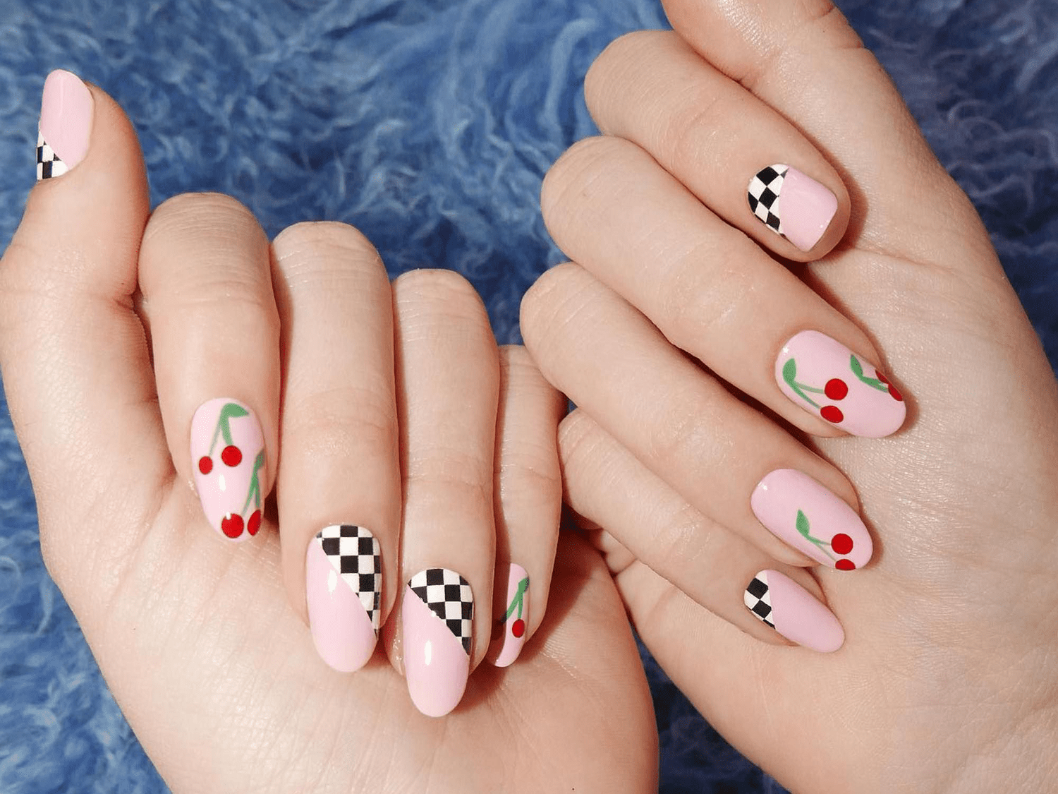 pink nails with cherry and checkerboard designs