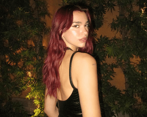 Dua Lipa with dark red hair