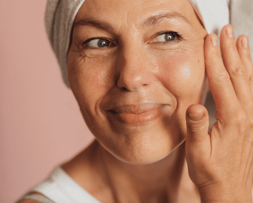 woman applying eye cream to eye area