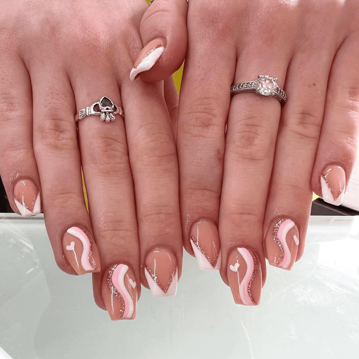 Rose gold, pink, white, and latte tan wavy manicure design