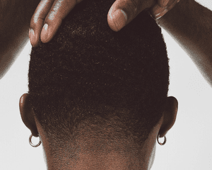 woman holding back of short hair on white background